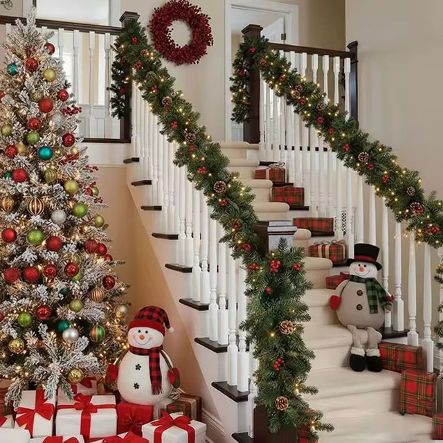 Pre-decorated green Christmas garland with built in lights, pine cones and red berries, 2.7m, on a staircase