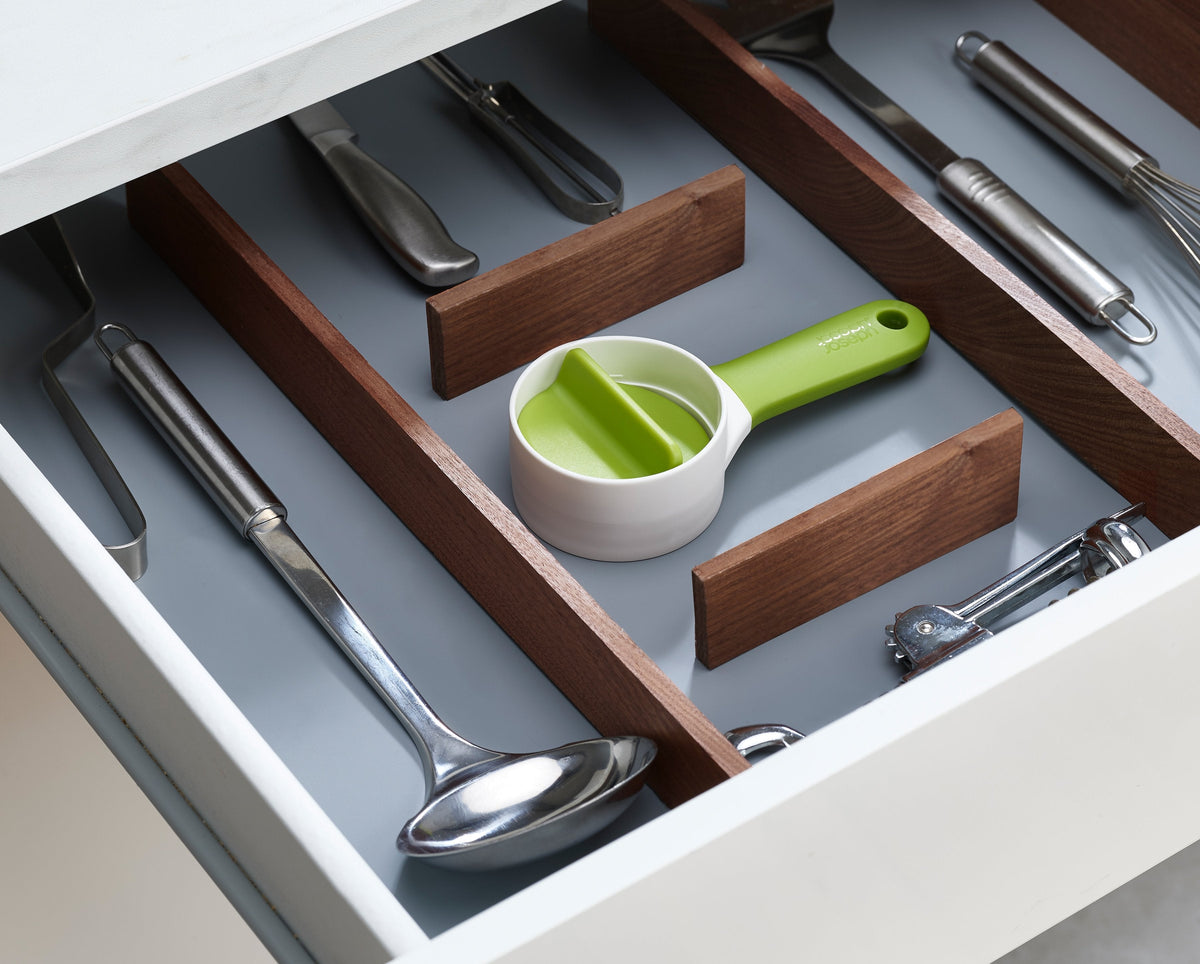 The green SpiroGo spiralizer shown with a bowl of spiralized vegetables.