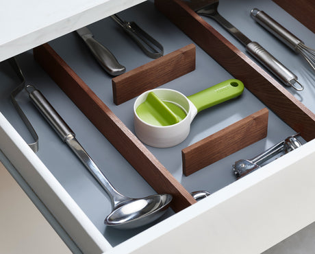 The green SpiroGo spiralizer shown with a bowl of spiralized vegetables.
